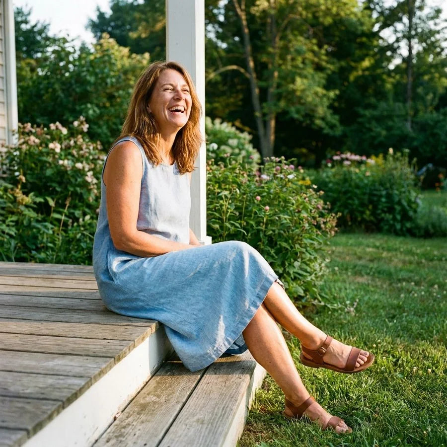 Smiling woman in a summer dress, relaxed, legs visible
