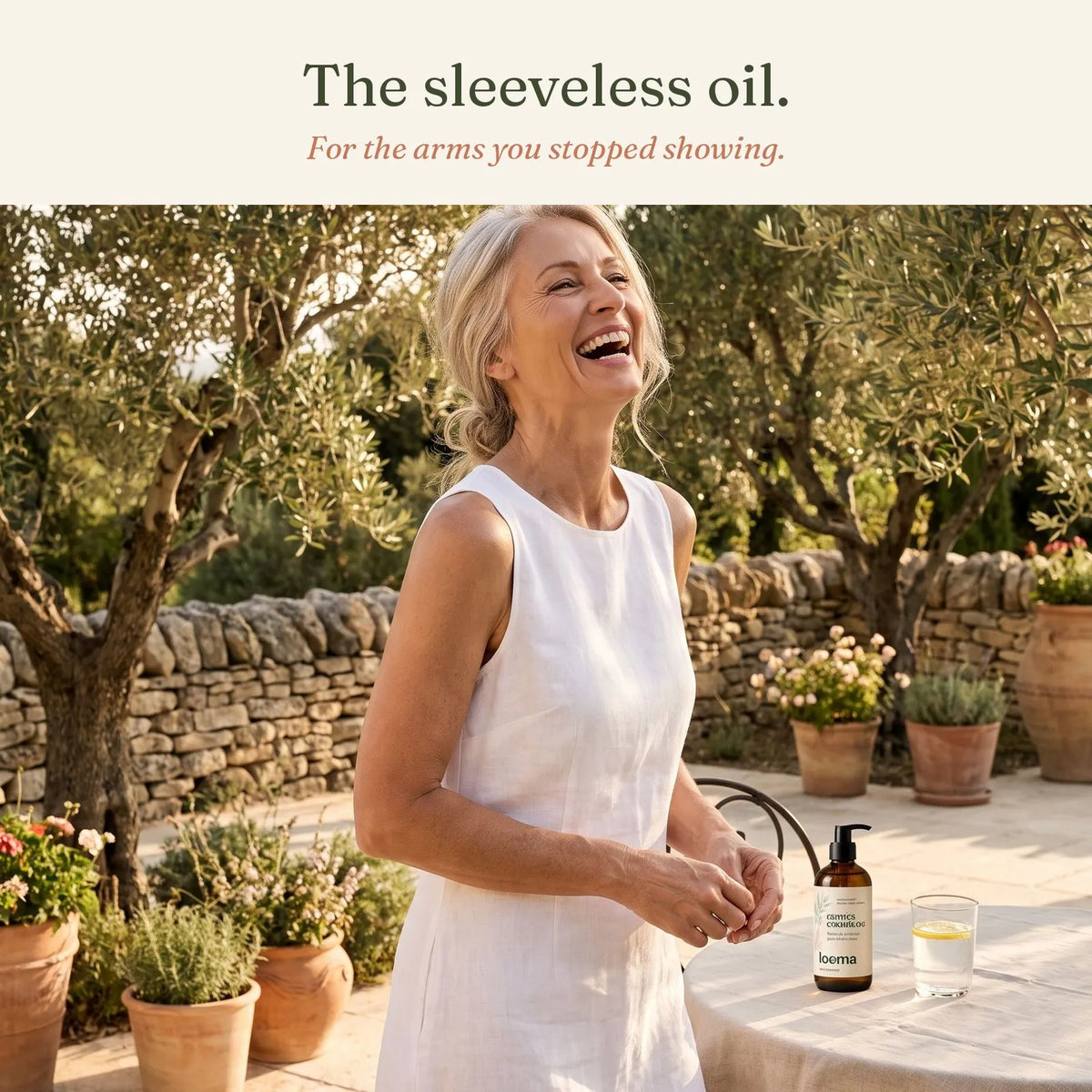 Woman in a sleeveless linen dress on a terrace in the South of France