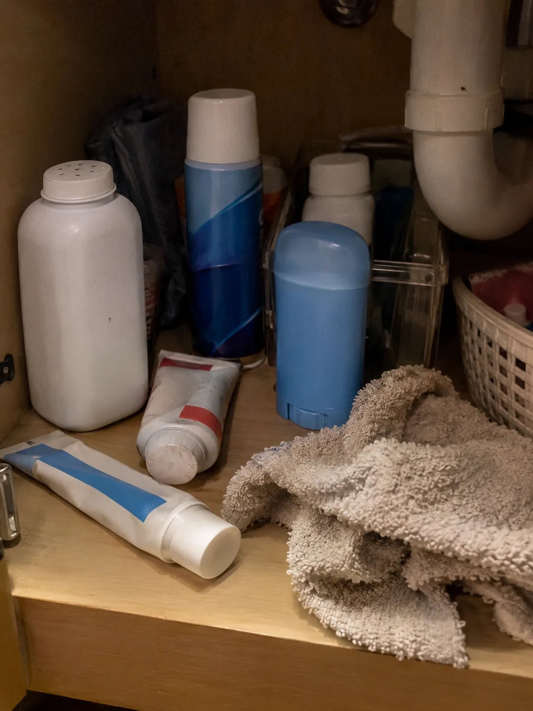 Bathroom cabinet full of powders, creams and deodorants